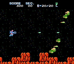 A blue spaceship with a rounded cockpit flies in the upper left against a black starfield dotted with white stars. Orange rounded obstacles or terrain pieces fill the bottom third of the screen. Green enemy spacecraft with yellow accents move across the right and center areas. The HUD displays SCORE (250), SEC (30), and E=20/20 at the top in white text. The sprite graphics use bold primary colors with visible pixelation typical of NES-era arcade shooters.