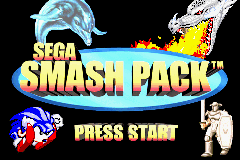 The Sega Smash Pack title screen displays the logo prominently at the top in yellow and orange gradient letters, with a blue dolphin illustration above it. Below the logo are four small character sprites arranged in a row: Sonic the hedgehog on the left, a white character in the center-left, a yellow character in the center-right, and a white character on the right. A yellow "PRESS START" button graphic appears at the bottom of the screen. The background is black with colorful graphical elements framing the logo area.