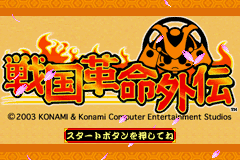 The title screen displays large stylized Japanese characters in orange and black at center, with a decorative circular emblem featuring geometric patterns in orange and black above them. Flames emerge from the left side of the text. A cream-colored background fills the upper half, transitioning to an orange band at the top. Copyright text for Konami appears below the main title. A smaller white menu option labeled in Japanese sits at the bottom left. The overall composition uses a flat, 2D pixel art style consistent with GBA hardware capabilities.