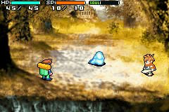 A top-down dungeon scene displays a blue-robed character centered in a golden cavern with brown rock walls and water at the bottom. Two sprite-based player characters stand to the left and right—one yellow-haired in green armor, one red-haired in pink. The HUD shows health bars and resource counters at the top in a horizontal layout. The art uses 16-bit GBA-era pixel sprites against a parallax background of textured stone and glowing amber lighting.