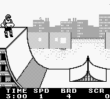 A black and white Game Boy screenshot showing a skateboarding character on the left performing a trick while leaning backward on a skateboard. A cityscape with tall buildings rendered in simple rectangular shapes fills the background in grayscale. The bottom of the screen displays game information: "TIME 5:00 UND 28.0" on the left and "3:00" on the right, with minimal UI elements typical of early 1990s Game Boy titles. The art uses low-resolution monochrome sprites against a light background.