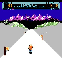 A skier in orange clothing stands on a white snowy slope in the center of the screen, flanked by two orange flags positioned to the left and right. Purple pixelated mountains with snow peaks occupy the upper portion against a blue sky, with green grass visible at the base. The UI displays "PLAYER 1 QUALIFYING RUN" with time and score indicators across the top in a cyan bar. Gray terrain forms the slope edges, creating a downhill perspective typical of early NES skiing games.