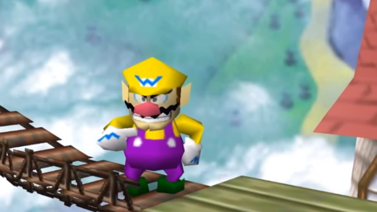 A character wearing a yellow cap with a blue W symbol, purple overalls, yellow shirt, and white gloves stands on a wooden platform. The character has a red nose and mustache. The background shows a cloudy sky in turquoise and white tones, with grass-covered platforms and wooden structures visible on the left and right edges of the screen. The character appears to be in a fighting game stage environment.