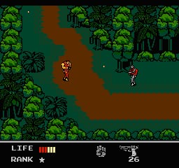 A jungle environment displayed in isometric perspective with dense green trees forming the borders and a winding brown dirt path in the center. Two armed soldier sprites are positioned on the path, one in the lower-left area and another in the middle-right section. The HUD at the bottom displays LIFE with three health bars, RANK marked with a star, and numerical values showing 8 and 26. The 8-bit sprite graphics use a limited color palette of greens, browns, and flesh tones against a dark background.