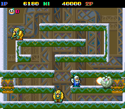A side-scrolling level displays two player characters at the bottom of the screen on a tiered platform layout with brown brick and green grass textures. The HUD shows score 6180, lives counter, health bar, and points 40000 at the top in a dark panel. Multiple enemies appear as yellow spherical creatures on various platform levels. The sprite-based graphics use a limited color palette typical of early 1990s arcade hardware, with white outlines defining platforms and character shapes against a darker patterned background.