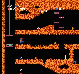 An underground cavern with orange brick platforms and black empty space forms the level layout. A small blue character sprite stands on the lower platform. White text displays numerical values in the upper portion of the screen, including "500" and other score indicators. The visual style uses low-resolution sprites and a two-color palette of orange and black with white text elements, typical of 1987 NES graphics.