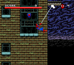 A Spider-Man level displays a brick-walled interior with a large purple demonic creature occupying the right side of the screen. The HUD shows a score of 0 at top-left and a health bar beneath it. A smaller character sprite, likely Spider-Man, appears in the center-left area. The level layout includes cyan-colored platforms and obstacles scattered across the brick background. A smaller window or portal element is visible on the left side of the play area, rendered in the SNES's 16-bit pixel art style with a limited but vibrant color palette.