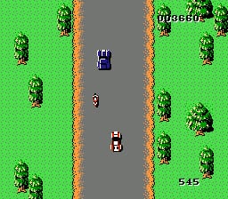 A vertically scrolling road view displays two vehicles on a gray asphalt highway bordered by tan dirt roads on both sides. Green grass fills the background with scattered trees positioned throughout the playfield. The upper vehicle moves upward while a second vehicle trails below it. The road narrows toward the top of the screen, creating a perspective effect typical of early driving games. Pixelated 8-bit graphics render the sprites and environment in a limited color palette of greens, grays, and browns.