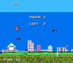 A horizontal scrolling shooter interface displays the player's submarine sprite on the left side against a blue sky background. A cityscape with tall buildings and structures sits along the bottom green terrain. Enemy aircraft sprites appear in the upper right area. The HUD shows "PHASE 1" and "LEFT 2" in white text centered at the top, with a score counter "20" in the upper left corner. Two small enemy sprites are visible mid-screen. The color palette features bright blue sky, green grass, and detailed pixel-art buildings rendered in the NES's characteristic 8-bit resolution.