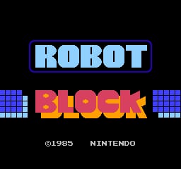 The title screen displays 'ROBOT' in large light blue pixelated letters at the top, with 'BLOCK' in red and yellow below it. Blue pixelated blocks flank both sides of the text. At the bottom, white text reads '©1985 NINTENDO' centered on a black background. The overall aesthetic uses an NES-era 8-bit pixel art style with a limited color palette of blue, red, yellow, and white against black.