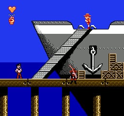 A side-scrolling platformer scene shows a character in blue clothing standing on a wooden platform against a bright blue background. A gray industrial structure with metal grating and stairs dominates the upper portion. Another character figure appears on the elevated platform, and wooden crates and a rope are visible near the structure's base. A gold heart icon floats in the upper left corner. The scene sits above a lower level with brown wooden pillars supporting the main platform, creating a multi-tiered level layout rendered in 8-bit sprite graphics.