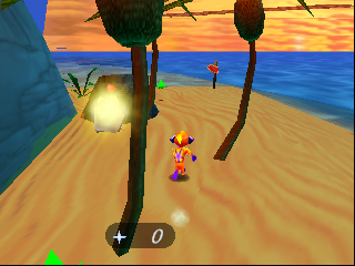 A colorful 3D beach scene with a yellow spherical character in the center-left of the sandy terrain. Two tall dark palm-like trees frame the scene, with a glowing orb suspended above the left tree. A small character with orange coloring stands on the sand to the right. The background shows a bright orange sunset sky meeting blue ocean water. A '+' crosshair and '0' counter appear in the lower-left corner of the screen. The art style uses flat shaded polygons typical of N64-era 3D graphics.