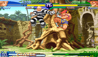 Two characters engage in combat in a tropical outdoor arena with stone architecture and palm trees. The left character wears dark clothing with spiky hair, while the right character is shirtless with reddish-blonde hair. A large ancient stone structure dominates the background. The HUD displays health bars at top (showing 4300 and 75 values), a timer in the center, and character names and health indicators at bottom. The sprite-based characters and detailed parallax background use the vibrant color palette typical of late-1990s arcade fighters.