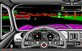 A first-person driving view displays a detailed car interior with dual round gauges, a steering wheel with red center hub, and dashboard controls in the foreground. The road ahead shows a red sports car on the asphalt with orange and green pixelated landscape elements creating a parallax scrolling effect. A small radar or map indicator appears in the upper right corner. The color palette emphasizes bright reds, purples, and greens typical of late-1980s CGA graphics.