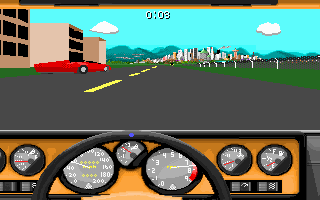 A first-person driving view shows a red race car on a gray asphalt road with yellow lane markings, heading toward a distant cityscape under a bright blue sky with white clouds. Green grass and brown buildings line the sides of the track. The bottom half displays an orange dashboard interface with six circular gauges arranged in two rows, showing various vehicle metrics including speed and RPM indicators.