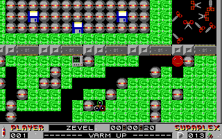 A bright green maze-based level displays the protagonist character in the center, surrounded by brown and gray stone blocks arranged in intricate patterns. The playfield fills most of the screen with a 2-bit color palette of lime green, black, brown, and gray. A row of brown orbs lines the top edge. Red enemy sprites appear in the upper right corner. The HUD at the bottom shows text including score, level indicator, and status readouts in a standard DOS-era font on a black background. Black tile borders separate the level design into distinct areas. The visual style uses low-resolution pixel art typical of early 1990s DOS games.