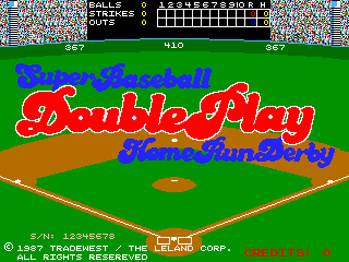 A colorful arcade title screen for Super Baseball Double Play Home Run Derby displays the game's logo in large red and blue letters centered on a bright green baseball field. A brown infield diamond and bases are visible below the title, with a small orange home plate at the center. The top of the screen shows a black HUD bar with score and game information. A thick pixelated colored border frames the edges. Copyright text for Leland Corp. and Tradewest appears at the bottom in red, dated 1987.