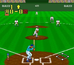 A baseball diamond viewed from behind home plate shows two teams positioned on the field during active play. The batter stands in the lower-left corner wearing a blue uniform, while pitcher and fielders in white uniforms are spread across the infield and outfield on a bright green grass surface with brown dirt base paths. The score display at the top reads 0-0 with 405 shown as game information. The UI includes a small field diagram in the lower-right corner, player count indicator on the left, and colored overlays marking player positions. The sprite-based graphics use SNES-era resolution with a wide-angle perspective of the ballpark.