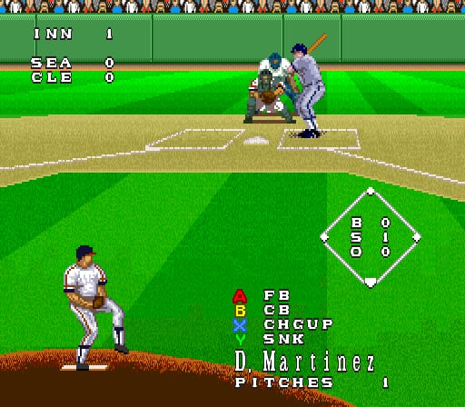 A baseball diamond viewed from center field during gameplay. The pitcher stands on the mound facing a batter in white uniform positioned in the lower left. A scoreboard in the upper left shows INN 1, SEA 0, CLE 0. The infield displays a diamond overlay with position labels (B, S, O, D, C, H, G, U, P, SNK) and player names including D. Martinez listed as pitcher. Pixel art crowds fill the bleachers along the top border. The field uses bright green grass with brown infield dirt and white baselines, typical of early 1990s SNES baseball game graphics.