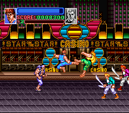 The arcade-style beat-em-up display shows two player characters in martial arts stances facing multiple enemies on a tile-floored stage. A red and gold decorative backdrop with ornate designs frames the action. The HUD at top displays red score counters reading "0099300" and "0" with player life bars. Colorful horizontal bar graphics in yellow, red, and blue span across the middle of the screen. The sprite-based characters are rendered in 16-bit resolution typical of early 1990s SNES hardware, with a dark parallax-scrolling background suggesting depth.