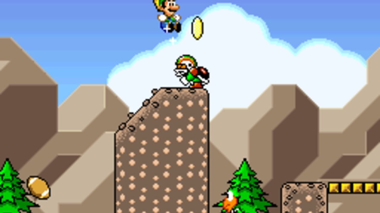 A pixelated platformer scene shows a character with a red cap standing atop a tall brown stone tower dotted with circular recesses. A second character floats in the upper left against a blue sky with white clouds. Green pine trees flank the base of the tower, and brown geometric mountain-like structures form the background. A yellow coin appears on the left side, and yellow brick blocks line the right edge. The art style features bright primary colors and 16-bit sprite resolution typical of SNES graphics.