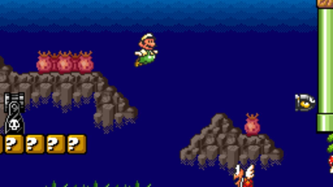 Mario in green outfit jumps mid-air above floating stone platforms against a deep blue background. Red spiky enemies sit atop the left platform, while another red enemy appears on a lower right platform. Yellow question mark blocks and a skull icon form the HUD at the bottom left. A green pipe structure with yellow accents appears on the right edge. Green grass tufts line the bottom of the screen. The scene uses 8-bit pixel art sprite style with parallax sky gradient.
