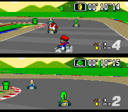 A split-screen Mario Kart race on a road with green grass borders shows two separate player perspectives. The top screen displays Mario in red kart leading, with Bowser's kart behind and a green item box visible; timer reads 00:10:14. The bottom screen shows Luigi in green kart in the lead position with a Koopa Troopa character trailing, timer at 00:10:15. Both screens display position indicators (4 and 2) and item counts in the lower-right corner. Pixelated Mode 7-style parallax scrolling creates the road perspective typical of early-1990s SNES Mode 7 effects.