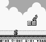 A small Mario sprite stands on a stone platform in the lower-left of the monochrome Game Boy screen. White clouds float against a gray sky in the upper portion. To the right, a spring mechanism with a character on top sits on a platform. The bottom status bar displays time counter at 0:03, coin count 0:001, and remaining time 01:59. Pixelated sprites and minimal color palette reflect the handheld hardware's technical capabilities.