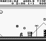A Game Boy screenshot displays Mario Land level one. At the top, white text reads "MARIO 02 -WORLD TIME" with score "0 -2-00 1-1 500". The monochrome playfield shows Mario as a small pixelated sprite on a platform in the lower left. A simple landscape spans the screen with blocky platforms, a small hill on the right, and a flagpole structure visible. Black enemies and obstacles appear as small sprites across the level. The art uses the characteristic low-resolution grid of Game Boy hardware with limited color depth.