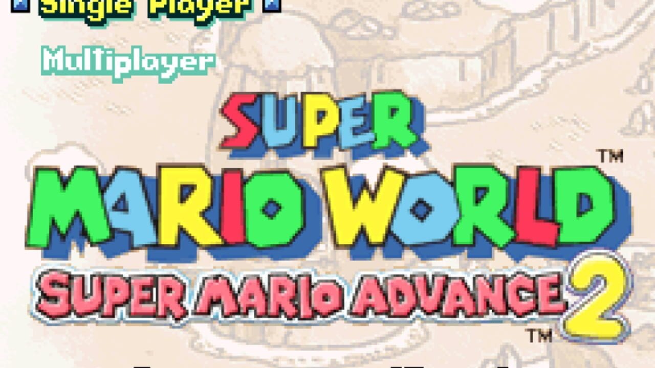 A menu screen displays 'Single Player' and 'Multiplayer' options in cyan text at the top, with the colorful pixelated title 'Super Mario World' rendered in large letters with alternating red, blue, yellow, and green blocks. Below it reads 'Super Mario Advance 2' in pink text with a yellow '2'. The background shows a faded map with structures and terrain typical of the Mushroom Kingdom. All text uses bold, chunky pixel fonts characteristic of Game Boy Advance graphics.