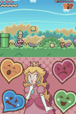 Princess Peach stands centered in the lower half wearing a pink dress and crown, surrounded by four large colorful heart icons in blue, pink, and green. Above her is a side-scrolling level view showing grassy terrain with green bushes and tan clouds, a green pipe on the left, and a small floating block in the center. The top displays a health bar with three circular face icons on the left and a score counter on the right. The art style uses bright pixel-based sprites typical of Nintendo DS handheld gaming.