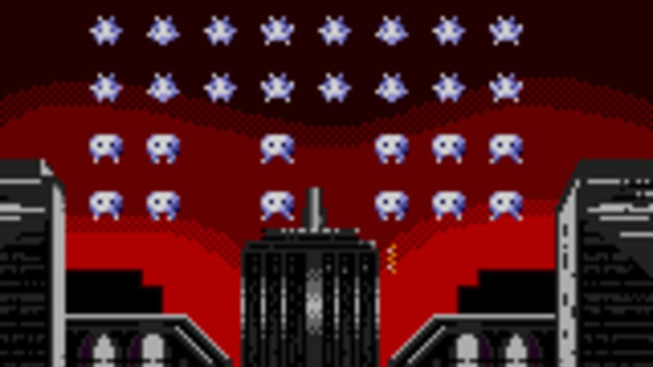 A space invaders-style gameplay scene with two rows of twelve blue alien enemies positioned across the upper portion of a red sky. Below them are black buildings with geometric silhouettes flanking a central black structure. White stars scatter across the dark background at the top. Yellow projectiles fire upward from the center building toward the descending enemies. The art style uses low-resolution pixel graphics with a limited color palette of red, black, white, and blue.
