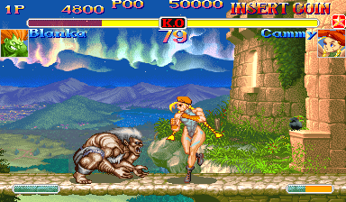 Two fighters clash in the foreground on a stone platform: one character performs a throwing move against an opponent on the ground. A mountainous landscape with blue sky and green valleys stretches across the background, with stone castle ruins visible on the right. The top HUD displays player health bars, round counter showing 73, and score numbers. The arcade UI includes a coin counter at top left and character portrait icons. Sprites are rendered in high resolution pixel art typical of early-1990s arcade fighting games.