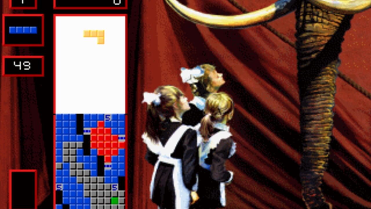 A Tetris gameplay screen with a red-bordered left sidebar displaying a blue HUD bar and score of 43. The main playfield shows a blue grid partially filled with tetromino blocks in black, red, and gray, with a yellow L-shaped piece at the top. Three female figures in black and white uniforms stand on the right side against a red draped background with a large decorative leg wearing a gold bangle visible above them. The visual style uses low-resolution pixel art with a theatrical stage setting aesthetic.