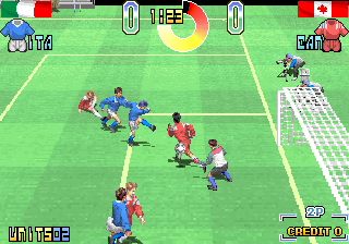 A soccer match viewed from an isometric angle shows two teams in red and blue jerseys competing on a green pitch. The ball is positioned near the center of the field with multiple players clustered around it. The top border displays country flags—Italy on the left and Canada on the right—with a yellow circular timer in the middle and score zeros for both sides. The bottom left shows "WINNER" text, while the right edge displays a minimap grid. The sprite-based graphics use bright primary colors with visible pixelation typical of early 1990s arcade hardware.