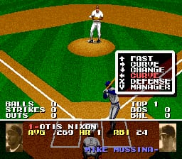 A baseball field viewed from behind home plate shows a pitcher on the mound in white uniform and a batter at the plate. The infield dirt forms a diamond shape against the green grass. The UI displays a scoreboard in the upper right corner with pitch information, while the lower left shows "BATTER OUT" with player names and game statistics. A blue "TOSSING" indicator appears near the pitcher, and the bottom panel shows player portraits and match data. The graphics use low-resolution SNES-era sprites and a limited color palette of greens, browns, and earth tones.