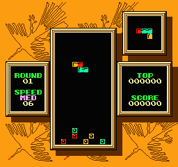 A Tetris 2 game screen displays a central black playfield with colored block pieces mid-fall, flanked by ornate golden-bordered panels. The left panel shows "ROUND 01" with red text on black background. The right upper panel contains a small preview of upcoming pieces, while the lower right panel displays "TOP" with six-digit score displays showing "000000" in yellow text. Orange decorative foliage elements surround the entire interface frame against a solid orange background.