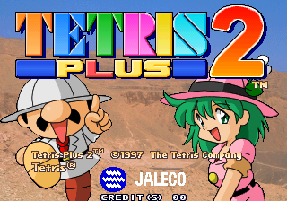 The Tetris Plus 2 title screen features the large colorful logo at the top in orange, blue, green, pink, yellow, and cyan letters with a red "2" symbol. Below the title, two cartoon characters stand on a sandy background: on the left, a character in a white baseball cap and brown outfit with a thumbs-up gesture; on the right, a character with green hair wearing a pink cowboy hat. Copyright text for Jaleco and The Tetris Company appears at the bottom, along with a Jaleco logo and what appears to be a score or timer display showing "00:00".
