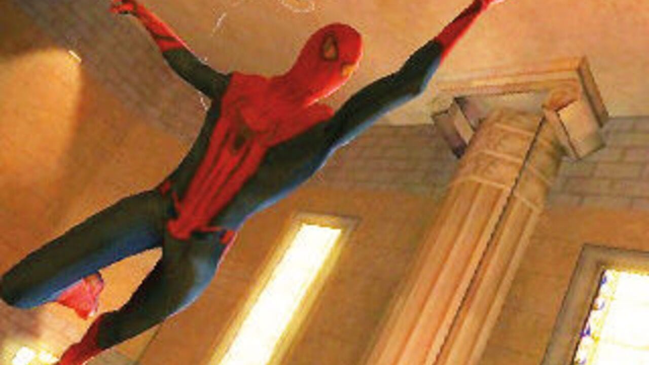 Spider-Man in red and blue costume swings diagonally across the frame with arms outstretched against a brown and tan interior setting with wooden paneling and white-trimmed doorways visible on the right side. The character sprite displays black webbing patterns on the limbs against warm-toned background geometry typical of early handheld game graphics.