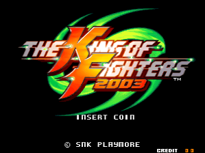 The King of Fighters 2003 arcade title screen displays the game's logo in large letters with stylized orange and yellow lettering against a green swirling graphic element on a black background. Below the logo, white text reads "INSERT COIN" centered on screen. At the bottom, copyright information shows "© SNK PLAYMORE" on the left and "CREDIT 3.5" on the right in small white text. The overall composition uses a typical arcade cabinet layout with prominent branding and coin-prompt messaging.
