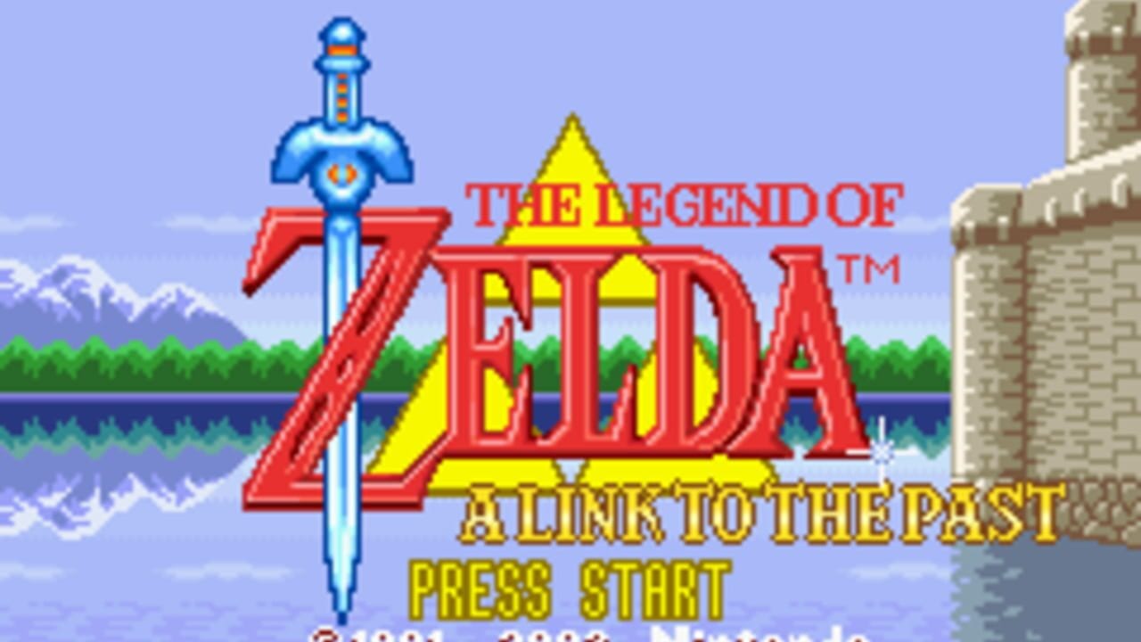 The title screen displays "The Legend of Zelda: A Link to the Past" in large red and yellow text centered on the screen. A blue sword with an orange crossguard and rounded hilt sits prominently to the left of the title. A yellow triangular shield appears above the text. The background shows a light blue sky with snow-capped mountains on the left, green forest trees in the middle, and a water body with a stone castle structure on the right side. Yellow text reading "Press Start" appears at the bottom in a pixelated font. The overall scene uses a bright 16-bit color palette typical of early 1990s game graphics.