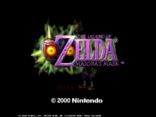 The title screen displays the Legend of Zelda: Majora's Mask logo prominently in the center, rendered in purple and silver lettering with green magical energy effects surrounding it. Below the logo stands a silhouetted character figure. The background is black with glowing green particle effects radiating outward. A copyright notice reading '© 2000 Nintendo' appears at the bottom of the screen. The overall composition uses a dark palette with bright accent colors typical of N64-era graphics.