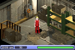An isometric view of a character in red clothing standing in a stone room with wooden furniture and green gates. A HUD at the bottom displays the time as 10:09 am, a resource counter showing 50, and a green health or status bar. The low-resolution sprite graphics and pixelated stone textures are characteristic of the Game Boy Advance's technical capabilities.