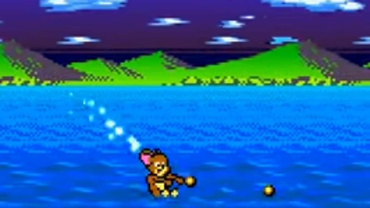 A brown mouse character with a pink bow floats in bright blue water in the center-left of the frame, with a golden sphere nearby. The background shows green rolling hills with yellow triangular markers and gray cliff faces, beneath a dark purple sky dotted with small white cloud shapes. The scene uses 8-bit pixel art style with limited color palette typical of Game Boy graphics.