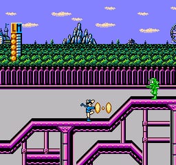 A player character in blue stands on purple pipe platforms in the foreground of a side-scrolling level. Green vertical fence segments form a fence line across the middle ground. A castle structure with multiple towers sits on the horizon against a blue sky with yellow clouds. Two small yellow fish sprites appear near the top corners. The scene uses a 16-bit NES color palette with distinct pixel-art sprites and a parallax background effect.