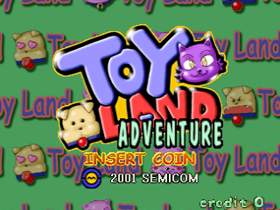 The title screen features a large purple and white 'Toy Land Adventure' logo with a purple cat character wearing orange positioned to its right. Below the title, yellow text reads 'INSERT COIN' and '2001 SEMICOM'. The background is green with a repeating pattern of small toy-like characters including bears and other figures. A 'credit 0' counter appears in the bottom right corner. The art style uses bright colors and pixel-based sprite graphics typical of early 2000s arcade games.