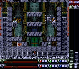 A top-down isometric view of a stone-walled puzzle level with multiple small character sprites positioned on colored tiles throughout the play area. The level features a symmetrical layout with purple stone walls, teal and gray floor tiles, and various interactive elements scattered across the grid. A horizontal status bar runs along the bottom displaying player information, score counters, and a life meter in red. The right edge shows a vertical score or level tracker. The overall aesthetic uses a 16-bit sprite palette with muted earth tones and clear tile-based grid structure typical of early 1990s SNES puzzle games.