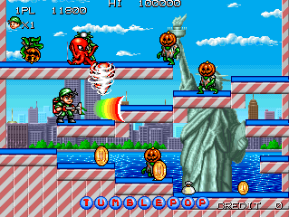 A two-player overhead view stage displays a colorful urban cityscape background with skyscrapers. The playfield features diagonal red and white striped platforms arranged in multiple tiers, with water visible at the bottom. Pumpkin enemies appear across the platforms alongside yellow pickup items. The top HUD shows player scores (31800, 100000), lives counter, and stage indicator. At the bottom, two rows of circular icons represent power-ups and collectibles, with "PLAYER1" and "PLAYER2" labels flanking the center.