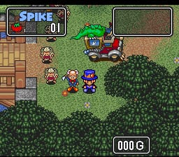 The game displays a top-down view of an outdoor grassy area with a dirt path. The protagonist, a small vampire character, stands in the center alongside two companion sprites. To the left sits a brown wooden building structure. Dense green bushes and foliage occupy the lower right and right portions of the screen. The UI shows "SPIKE" and "01" in the top-left corner within a bordered panel, while "000 G" appears in white text at the bottom-right, indicating the player's current currency or score. The graphics use 16-bit SNES-era pixel art with a muted color palette of greens, browns, and earth tones.