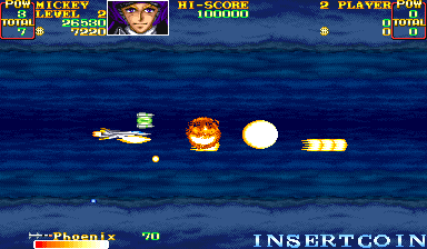 A blue water-and-sky background with a scrolling parallax ocean layer. A yellow aircraft sprite is visible on the left side, with orange and white enemy aircraft or projectile sprites scattered across the center and right. A white circular object floats in the mid-right area. The top of the screen displays a score panel with 'MICKEY' text, player power indicators, a Hi-Score counter showing 00000, and a Player 1 POW counter at 0. The bottom left shows 'Phoenix' with a score of 70, and 'INSERT COIN' text appears at the bottom center. This is an arcade vertical-scrolling shooter gameplay screen.
